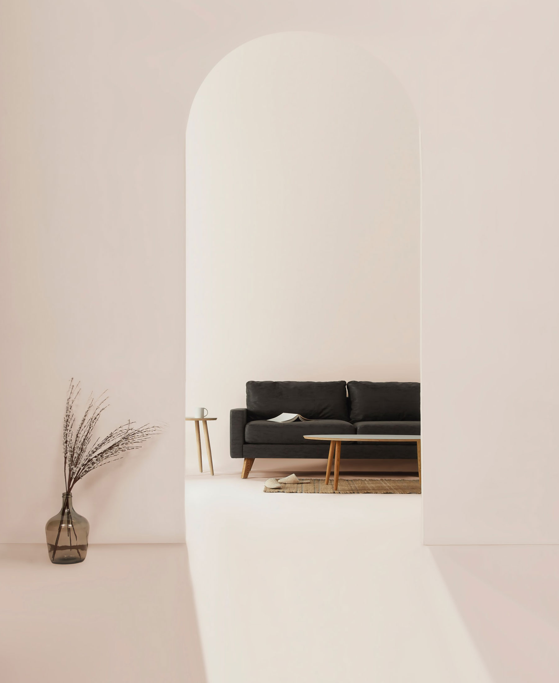 A black couch in a white room.